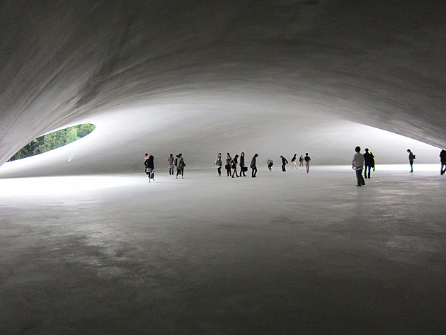 When we arrived at the Teshima Art Museum it was all that I expected and more. The Museum is an organic concrete structure that creates an interplay with the elements of water, wind, wood and light that is both intimate and dynamic. Water slowly drips and seeps onto the floor through small ping-pong like balls and holes in the concrete. There were about 50 people in the Museum when our tour group visited during the Triennale. There was a quietness in the space and what I would call a reverence for the water and the shapes it formed. As Triennale visitors were not permitted to take photos inside the museum, this image is from the arquiscopio.com website. These external photos are unable to show the terraced rice fields in the countryside surrounding the museum. These have been restored as part of the reinvigoration of Teshima Island and exemplify the aim to highlight local landscapes, history and way of life.